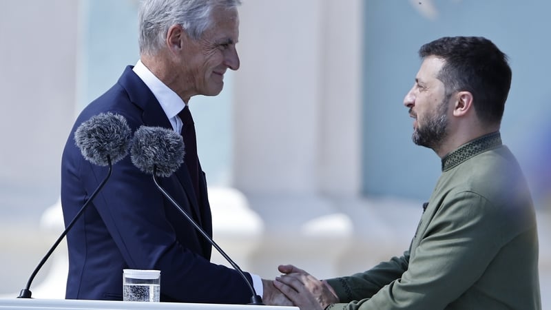 Norway's Prime Minister Jonas Gahr Store congratulates Ukrainian President Volodymyr Zelenskyi at an Independence Day event in Kyiv
