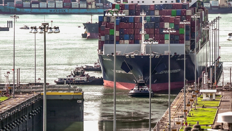 A cargo ship navigates through the Panama Canal in the area of the Cocoli Locks