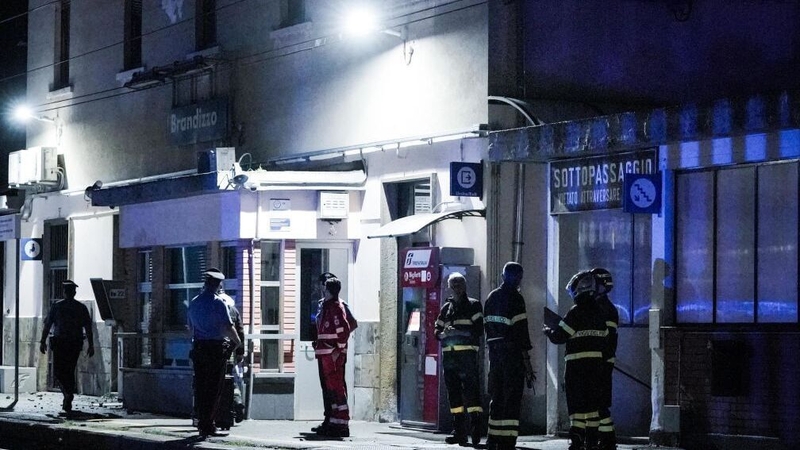 Emergency service workers at the train station in Brandizzo, near where the deaths occurred