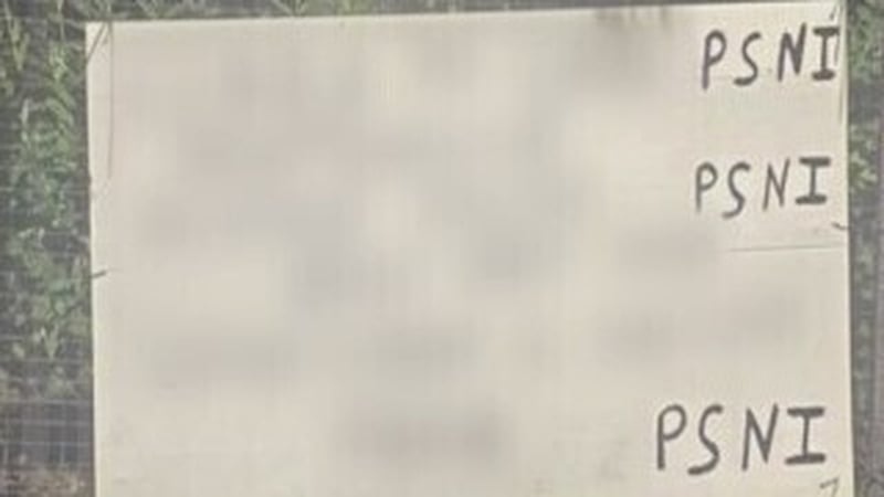 A poster at a bus stop in the Co Derry village of Dungiven, which claims to show details of three PSNI officers