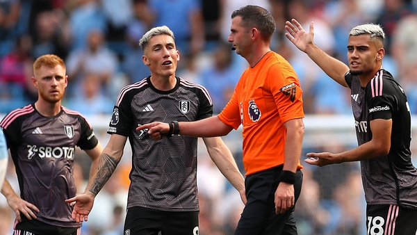 Fulham players protest to referee Michael Oliver after Nathan Ake's controversial goal