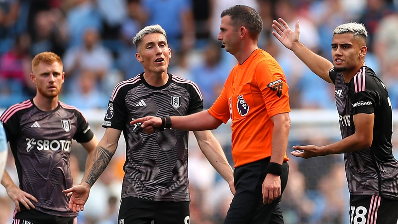 Fulham players protest to referee Michael Oliver after Nathan Ake's controversial goal