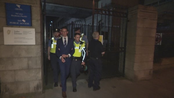 Enoch Burke is led away from the Four Courts in Dublin tonight