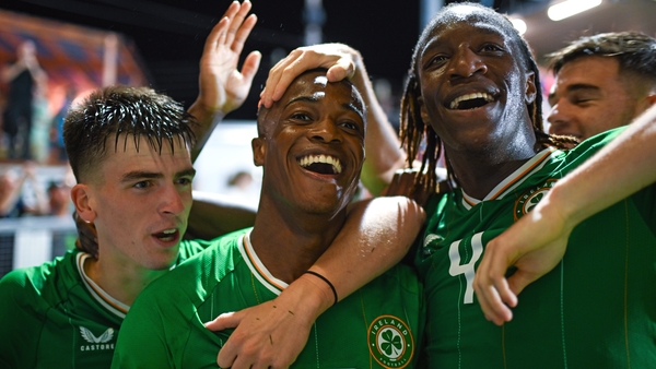 Aidomo Emakhu celebrates with team-mates Andrew Moran and Bosun Lawal after scoring the winner