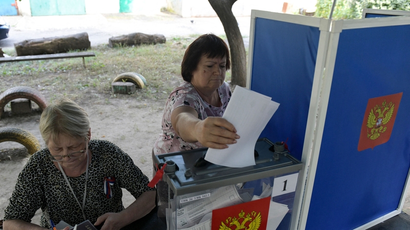 A woman casts her ballot at a mobile polling station during early voting for local elections organised by the Russian-installed authorities in Donetsk