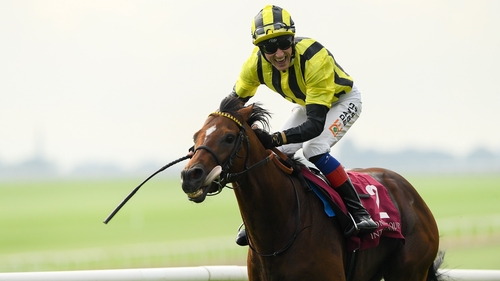 A beaming David Egan crosses the finish line on Eldar Eldarov
