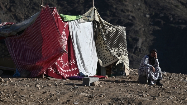 A woman sits outside her makeshift shelter in the mountain village of Moulay Brahim in the central province of Al-Haouz