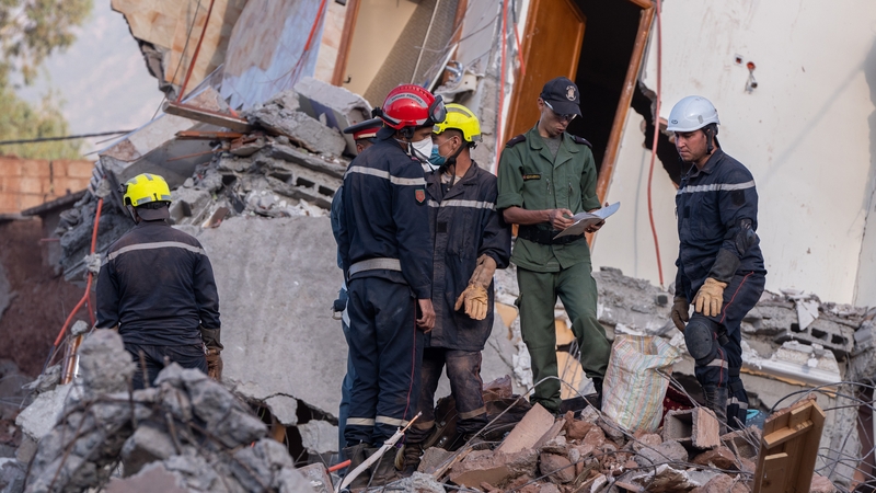 Rescue workers at the rubble of a collapsed building following the earthquake in Ouirgane