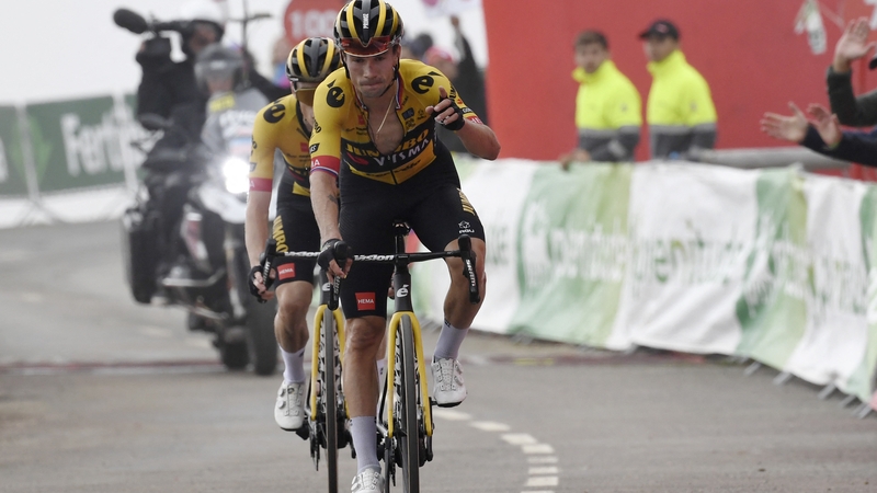 Primoz Roglic gestures as he arrives to cross the finish line in first place followed by Team Jumbo-Visma's team-mate Jonas Vingegaard