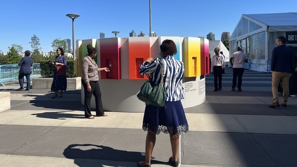 Visitors to the UN look at a Sustainable Development Goals display
