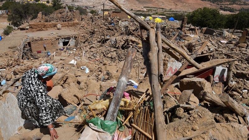 An earthquake survivor looks for belongings amidst destruction in the Moroccan village of Ardouz