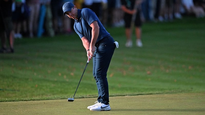McIlroy putts through the shadows on the last