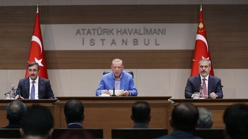 Recep Tayyip Erdogan (C) speaks during a press conference before his flight to United States at the Ataturk Airport in Istanbul