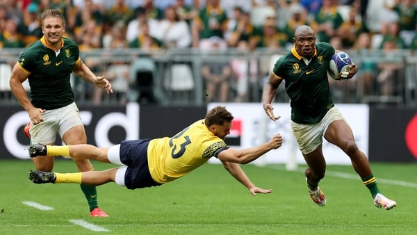 Makazole Mapimpi, one of two South African players to score hat-tricks, breaks past Romania's Gabriel Pop for his third try of the game