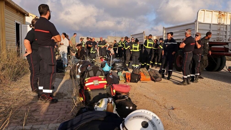 Members of the French Rescue Team gather upon arrival at al-Abraq Airport in Libya to assist in relief work
