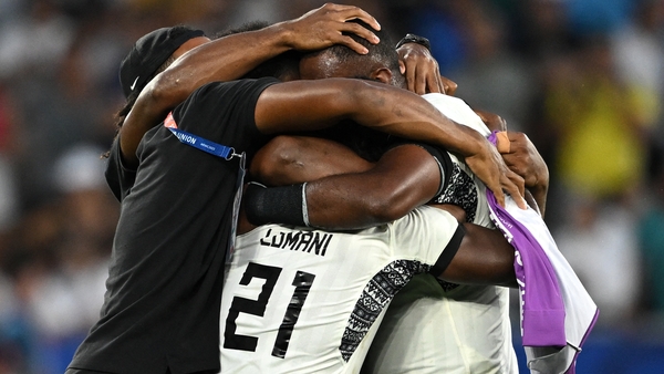 Fiji's players and staff celebrate a famous victory
