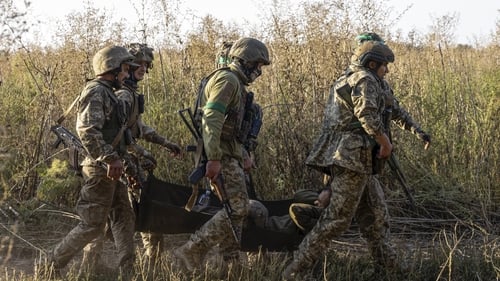 Ukrainian forces evacuate a wounded soldier as both sides traded artillery volleys southeast of Kupyansk earlier this months