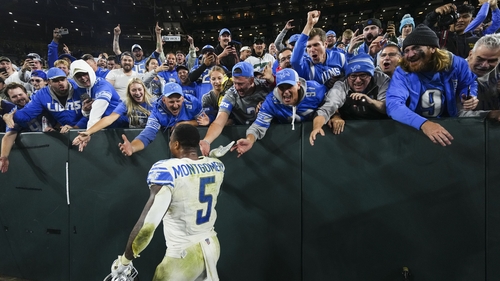 David Montgomery celebrates with Detroit Lions fans at Lambeau Field