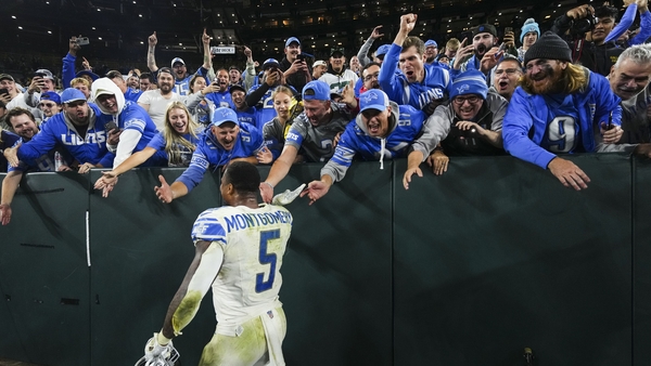 David Montgomery celebrates with Detroit Lions fans at Lambeau Field