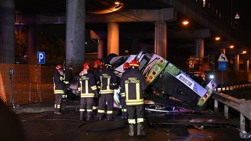 Firefighters work on the site of the bus crash in Mestre, near Venice