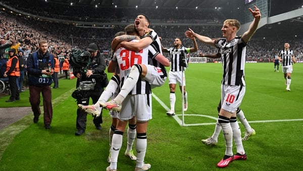 Sean Longstaff celebrates with Miguel Almiron after scoring Newcastle United 's third goal