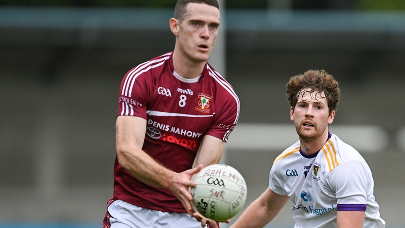 Brian Fenton of Raheny in action against Crokes' Liam Flatman