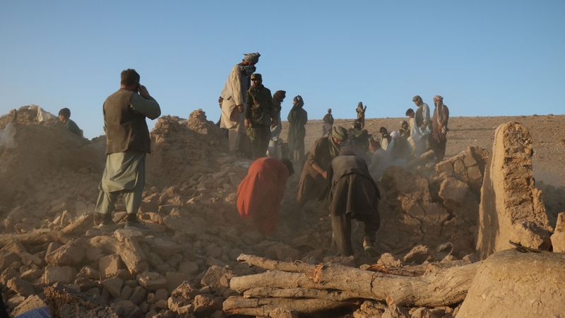 Afghan residents clear debris from a damaged house after earthquake in Sarbuland village of Zendeh Jan district of Herat