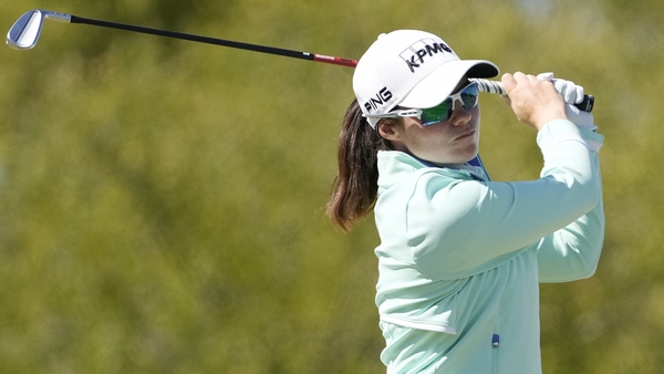 Maguire hits her tee shot on the 16th