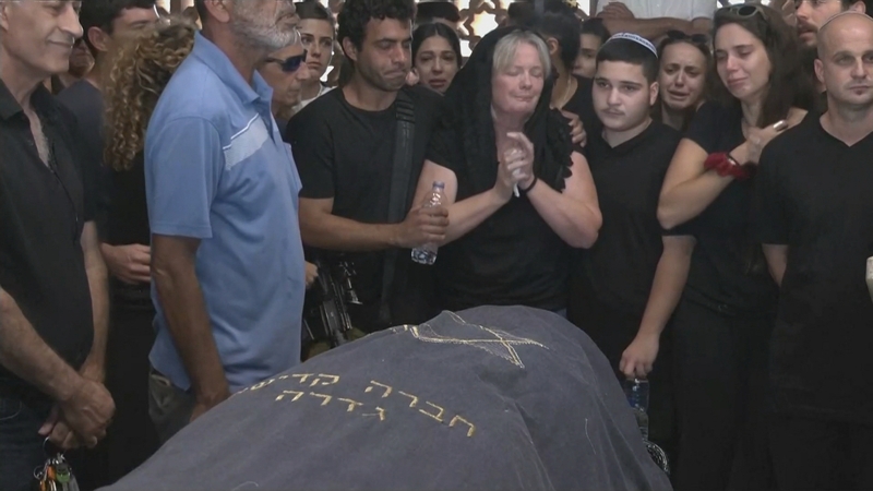 Members of Kim Damti's family mourn her death at her funeral at the cemetery in Gedera, southern Israel