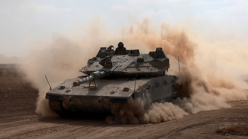 An Israeli army Merkava battle tank deploys with others along the border with Gaza in southern Israel