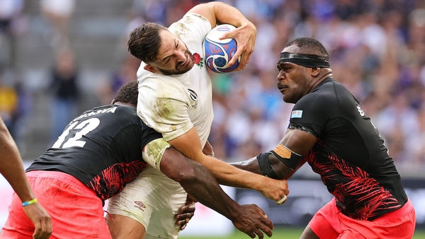 Jonny May of England is tackled by Josua Tuisova and Levani Botia of Fiji