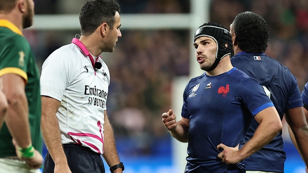 France's scrum-half and captain Antoine Dupont speaks with referee Ben O'Keeffe during their quarter-final defeat to South Africa