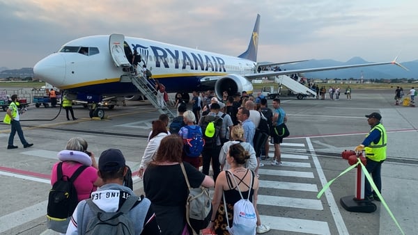 People board a Ryanair plane at the airport in Bergamo in Italy