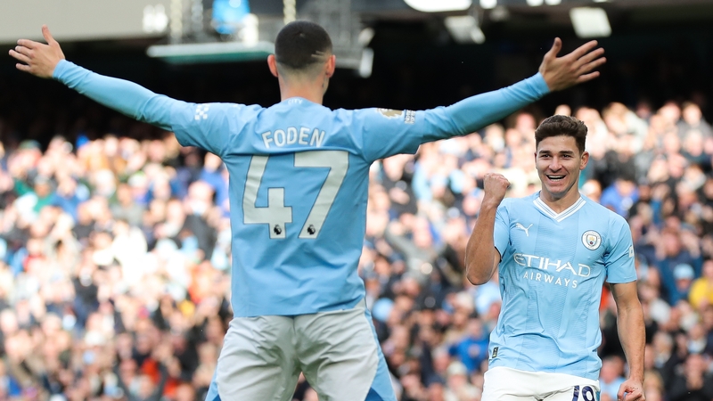 Phil Foden (L) celebrates with Julian Alvarez