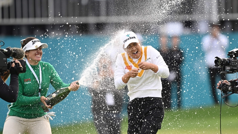 Minjee Lee (R) is sprayed with champagne by fellow Australian Hannah Green (L) as she celebrates her victory