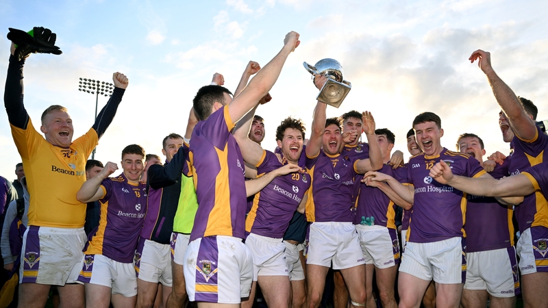 Andy McGowan, centre, and team-mates celebrate with the trophy