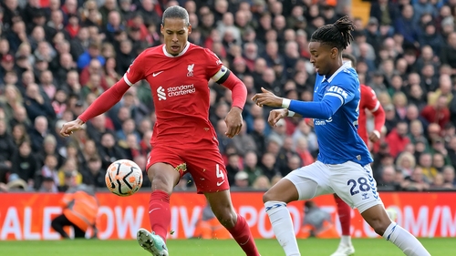 Virgil van Dijk (L) challenges Everton's Youssef Chermiti for the ball