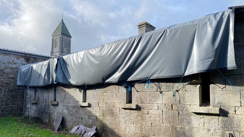 A heavy tarpaulin was placed over the roof in 2021.