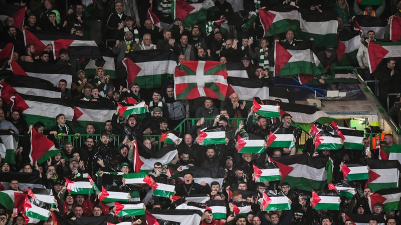 Celtic supporters display Palestinian flags prior to the start of the Champions League game against Atletico Madrid