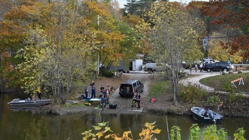 Law enforcement officials prepare to search the Androscoggin River in Maine