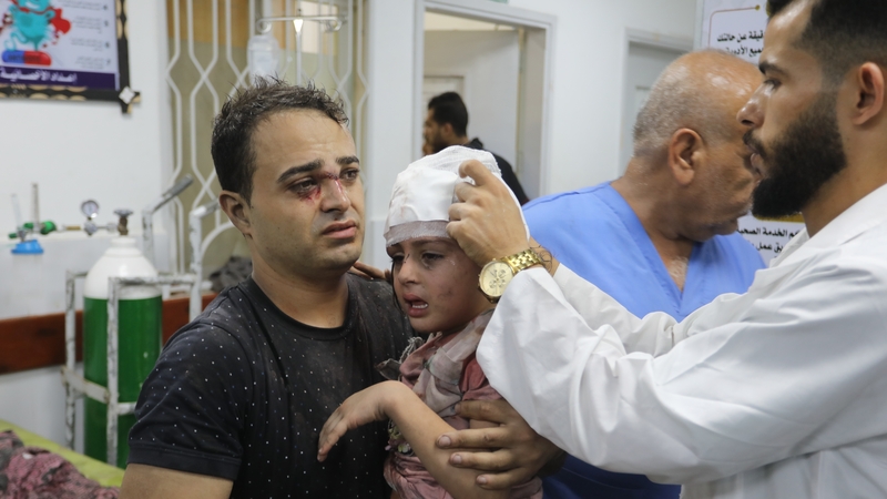 Medics attend to a child injured during an airstrike on Rafah