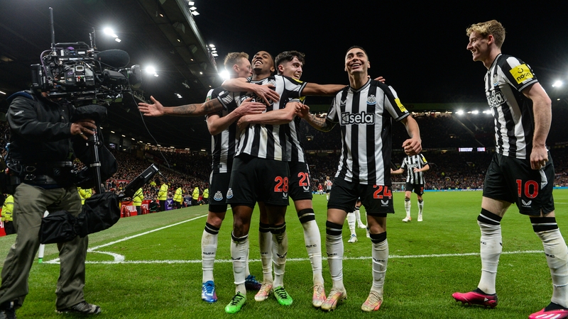 Joe Willock is embraced by his Newcastle team-mates after scoring the third goal at Old Trafford