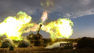 An Israeli artillery unit fires during a military drill in the annexed Golan Heights near the border with Lebanon