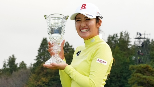 Mone Inami celebrates with the trophy