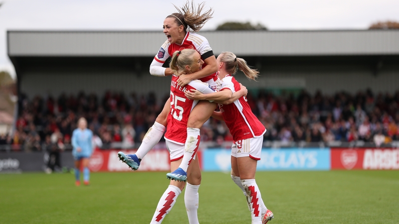 Katie McCabe celebrates with goalscorer Stina Blackstenius