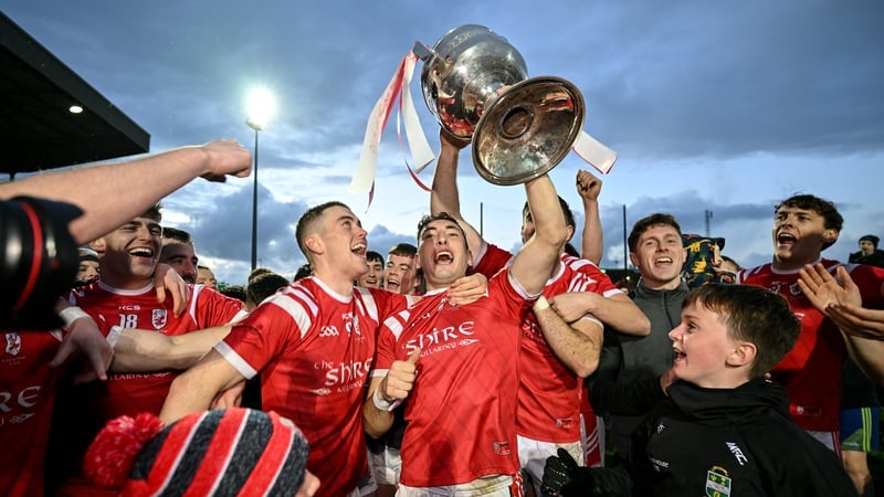 East Kerry captain Paudie Clifford and teammates, including Ronan Buckley and David Clifford, celebrate with the Bishop Moynihan Cup