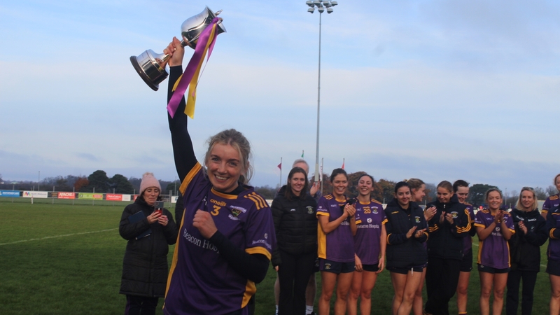 Kilmacud Crokes captain Emer Sweeney hoists the Bill Daly Trophy aloft