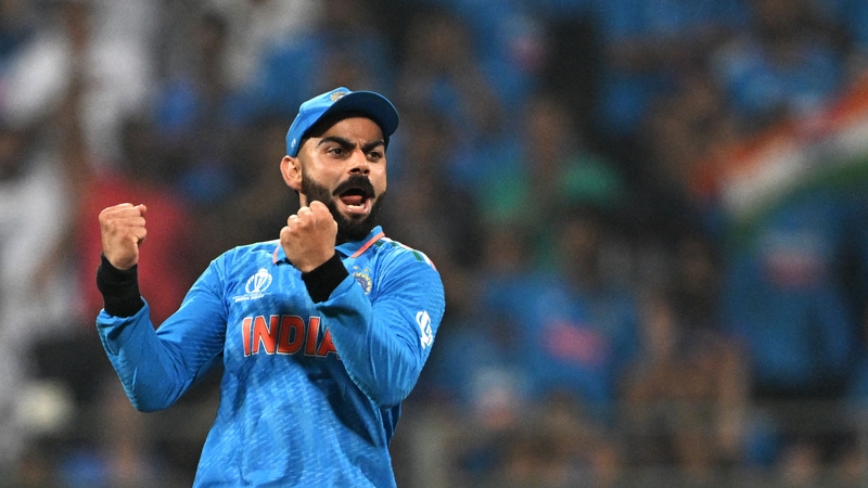 Virat Kohli celebrates after the dismissal of New Zealand's Daryl Mitchell