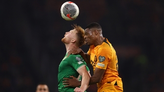 Liam Scales wins a header under pressure from Denzel Dumfries