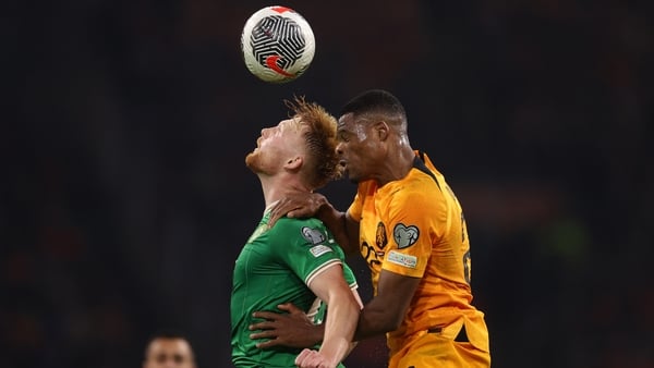 Liam Scales wins a header under pressure from Denzel Dumfries